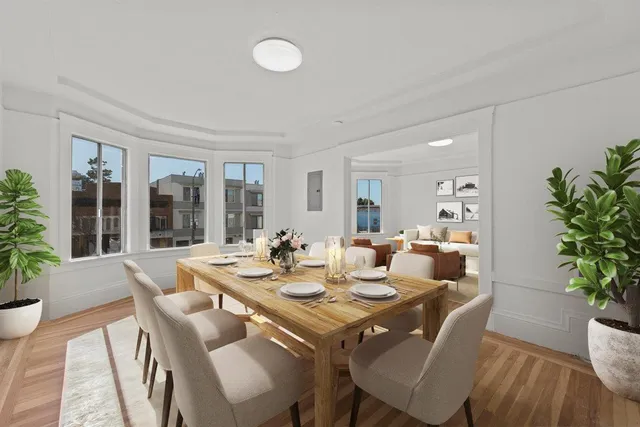 a view of a dining room with furniture and wooden floor