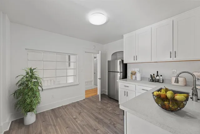 a kitchen with stainless steel appliances a stove microwave and sink