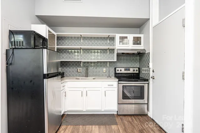 a kitchen with a stove and a refrigerator