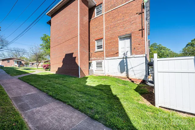 a view of a house with a big yard and potted plants