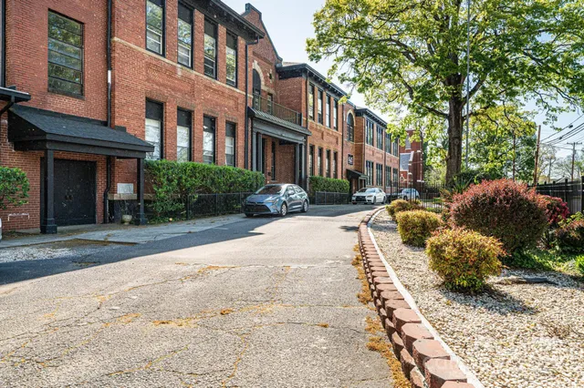 a city street lined with buildings and cars parked in front of it