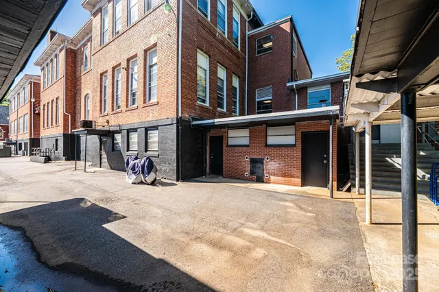 a front view of house with yard and trees around
