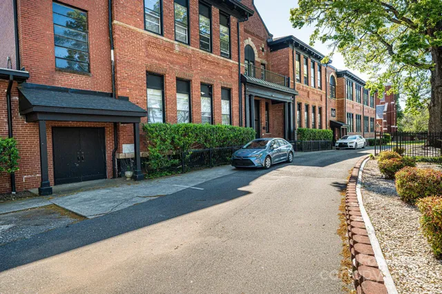 a front view of a building with yard and green space