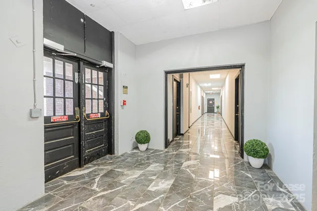 a view of a hallway and a livingroom with wooden floor