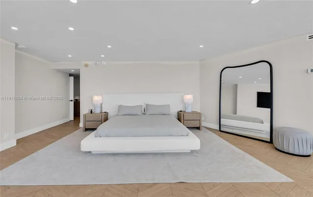 a spacious bedroom with a bed and a mirror