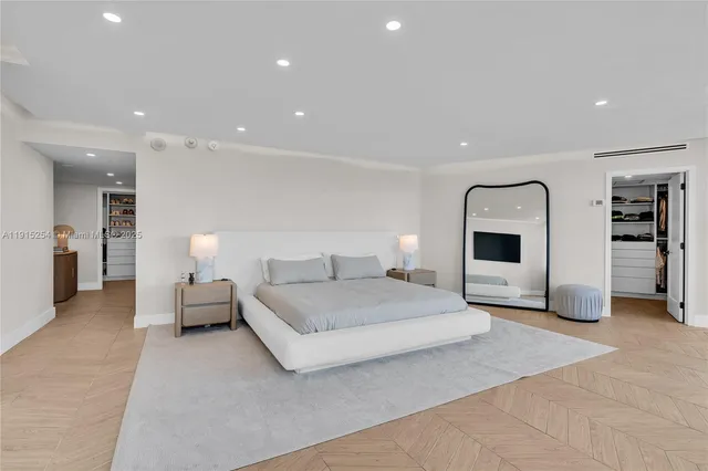 a spacious bedroom with a bed and a couch