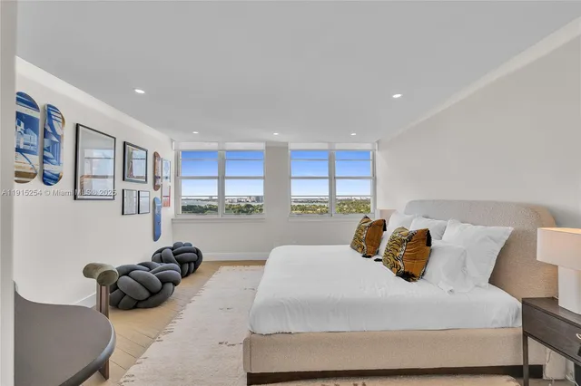 a bedroom with a bed and a large window