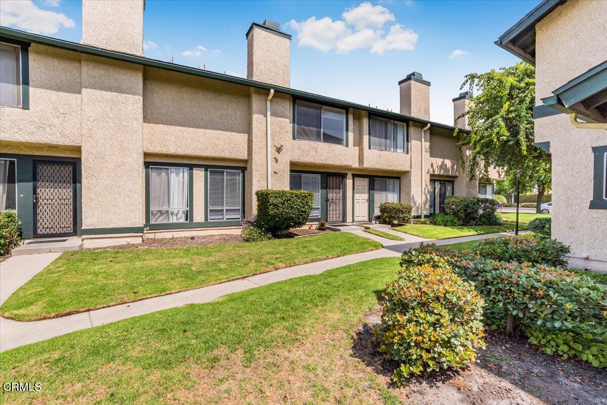 a view of a house with a yard and plants