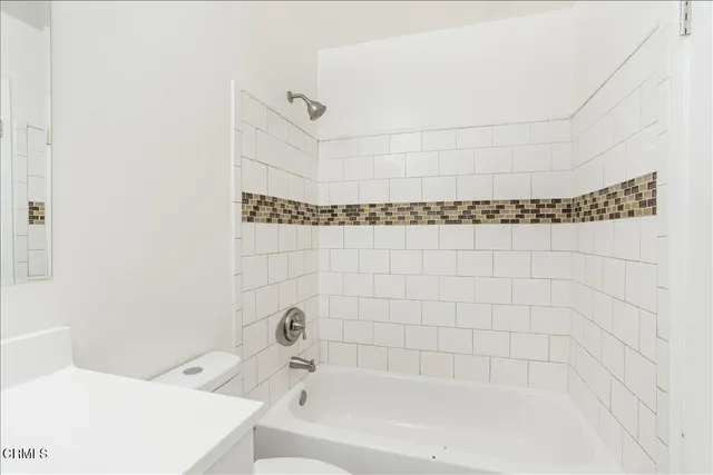 a bathroom with a bathtub and shower