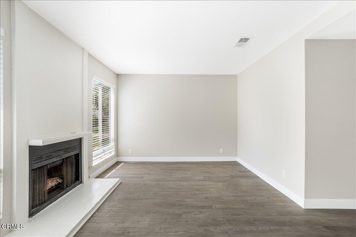 5147 Perkins Road Oxnard, CA 93033 - Photo 6 of 42 an empty room with windows and fireplace