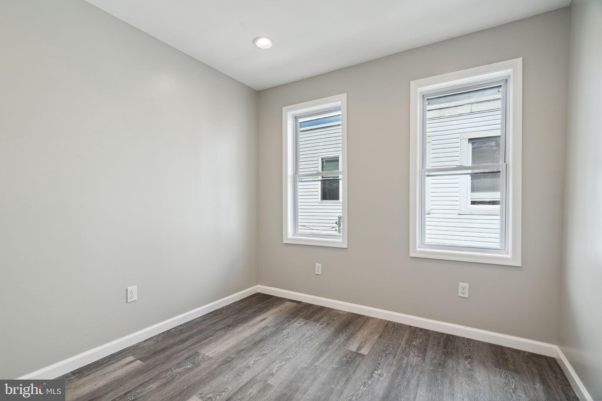 2033 Emily Street Philadelphia, PA 19145 - Photo 18 of 42 a view of an empty room with wooden floor and a window