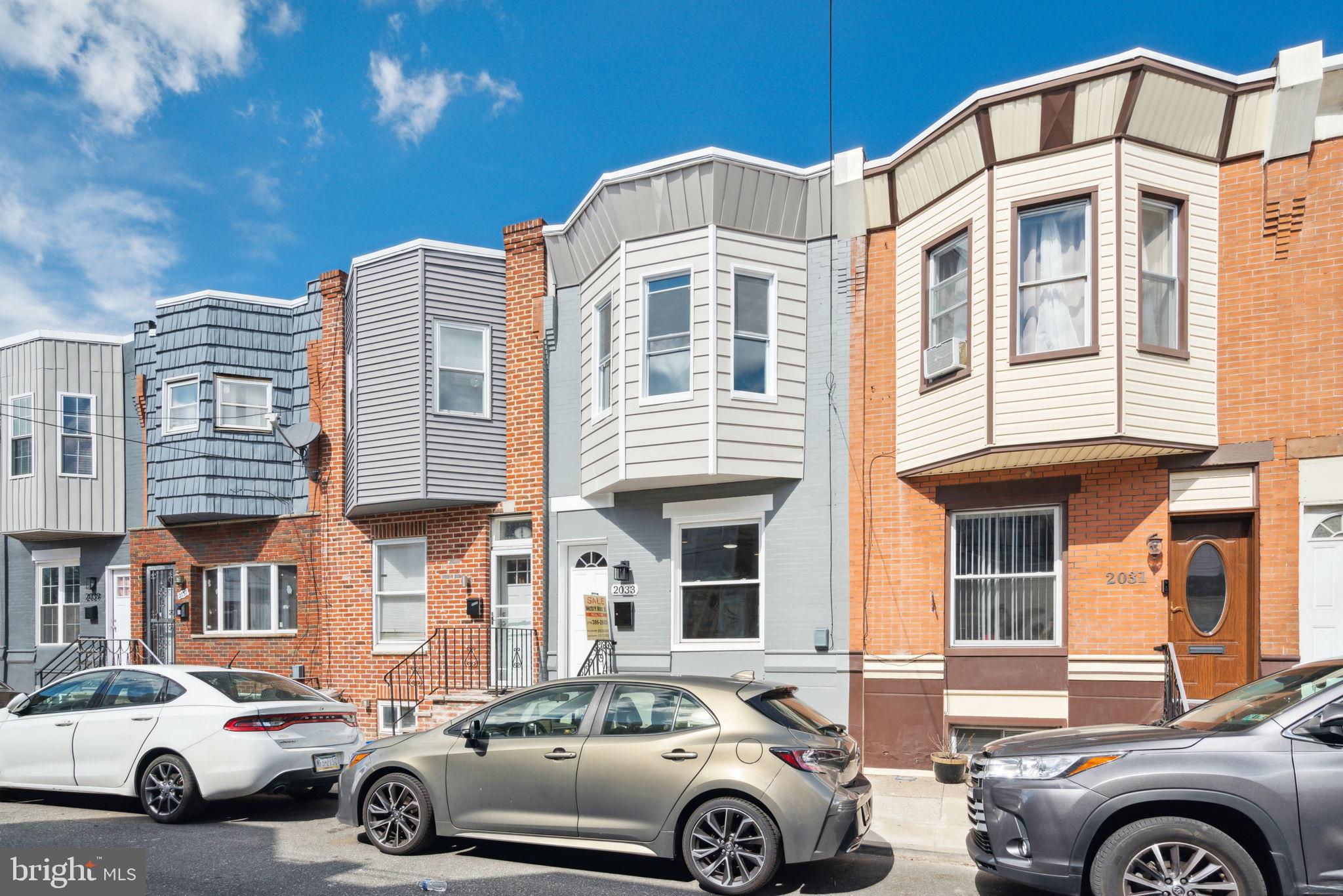 2033 Emily Street Philadelphia, PA 19145 - Photo 2 of 42 a front view of a residential apartment building with a parking space