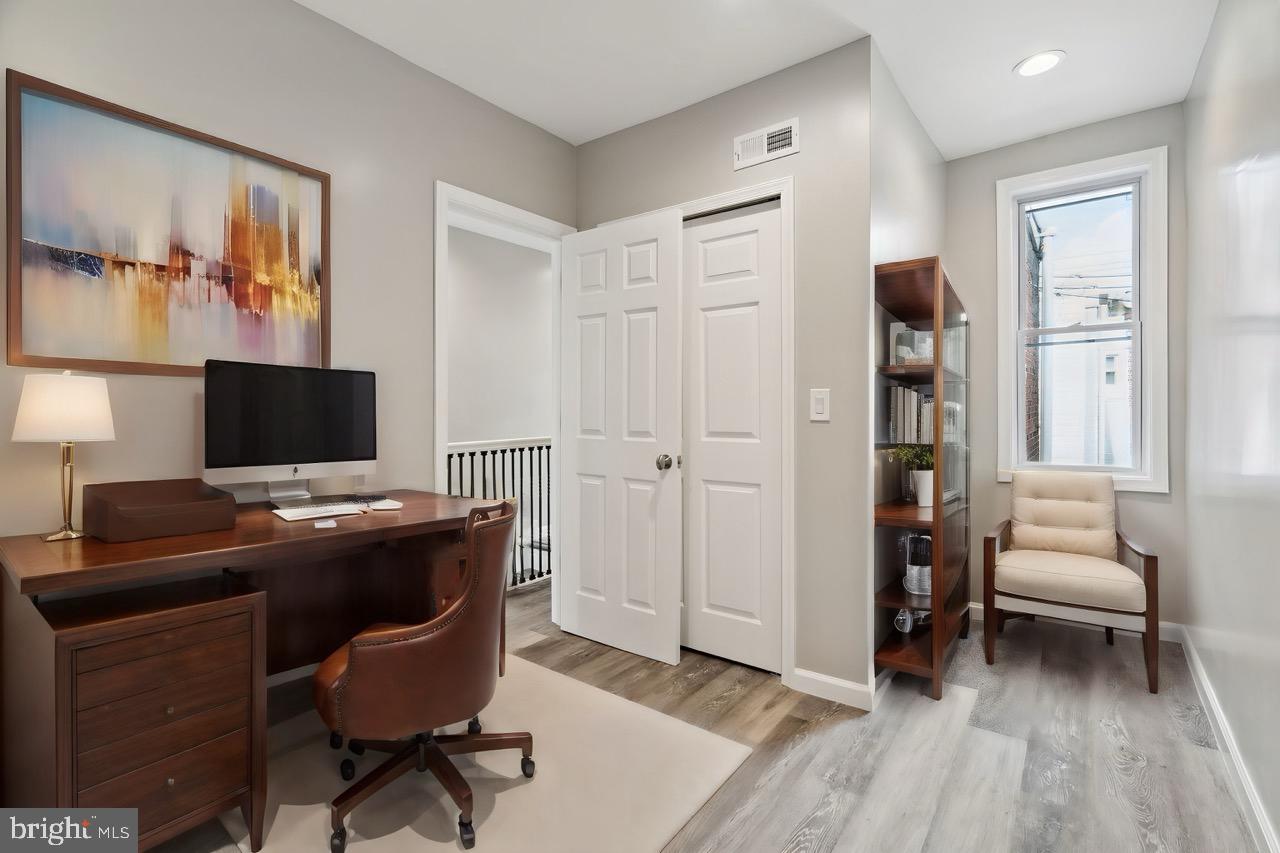 2033 Emily Street Philadelphia, PA 19145 - Photo 24 of 42 a view of a workspace with furniture and a window