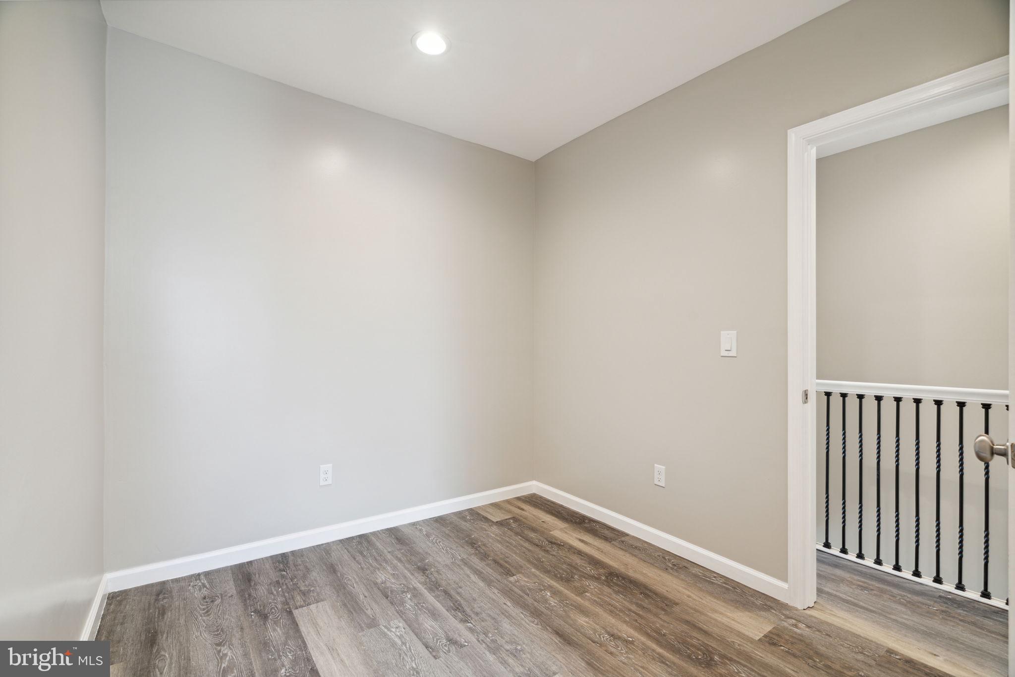 2033 Emily Street Philadelphia, PA 19145 - Photo 25 of 42 a view of an empty room with wooden floor
