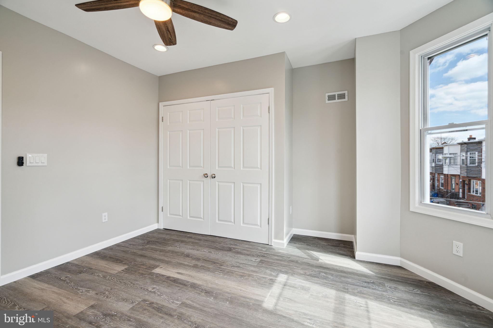 2033 Emily Street Philadelphia, PA 19145 - Photo 32 of 42 an empty room with chandelier fan and windows