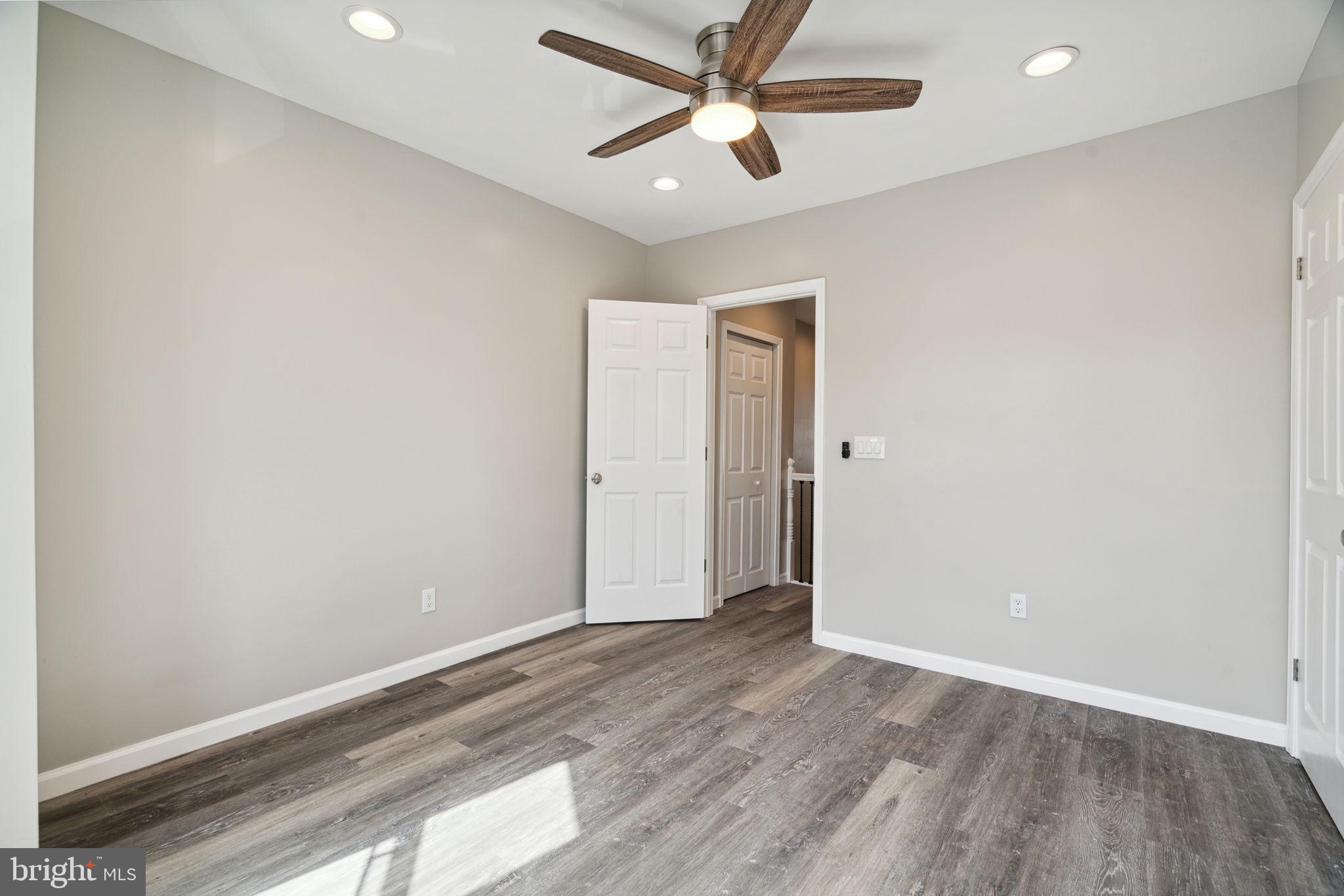 2033 Emily Street Philadelphia, PA 19145 - Photo 33 of 42 an empty room with wooden floor and ceiling fan