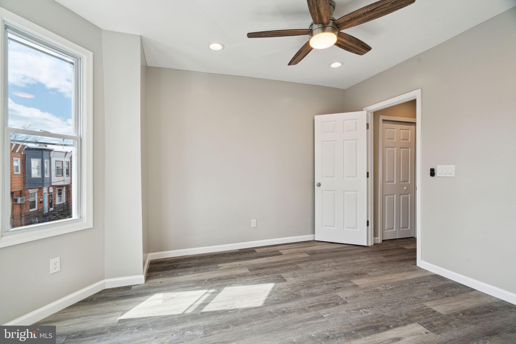 2033 Emily Street Philadelphia, PA 19145 - Photo 34 of 42 a view of an empty room with window and wooden floor