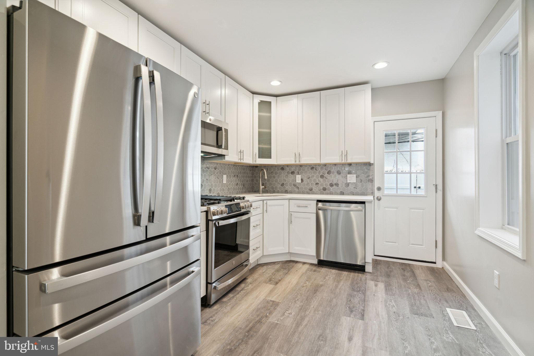 2033 Emily Street Philadelphia, PA 19145 - Photo 8 of 42 a kitchen with a refrigerator stove and sink