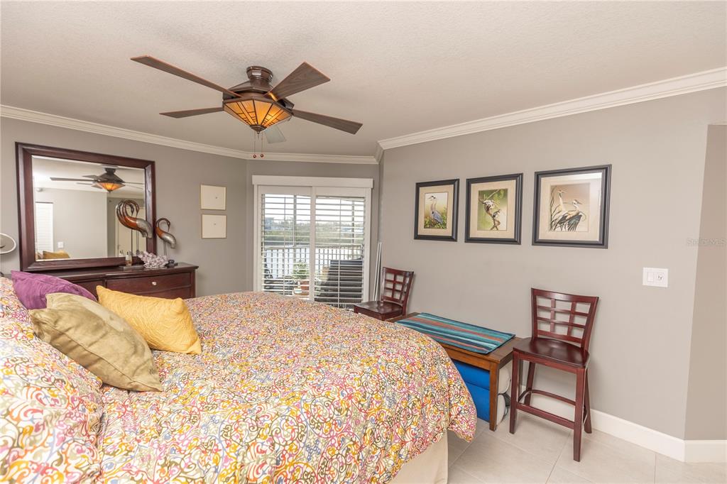 1401 South McCall Road, Unit B306 Englewood, FL 34223 - Photo 11 of 25 a bedroom with a bed and a large window