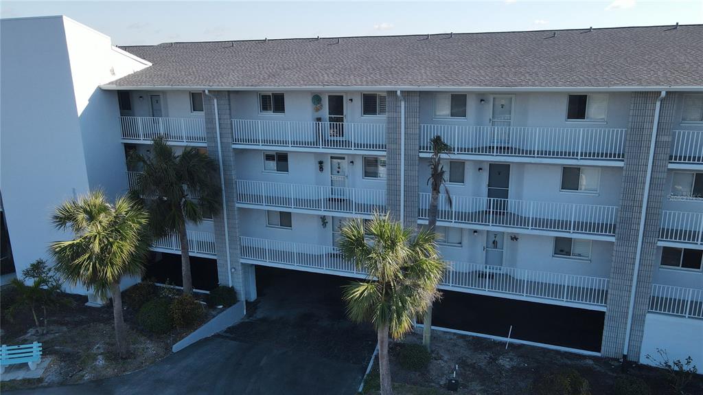 1401 South McCall Road, Unit B306 Englewood, FL 34223 - Photo 2 of 25 a front view of a house with a yard