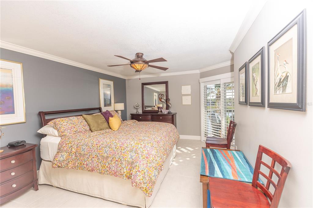 1401 South McCall Road, Unit B306 Englewood, FL 34223 - Photo 10 of 25 a bedroom with a bed and wooden floor
