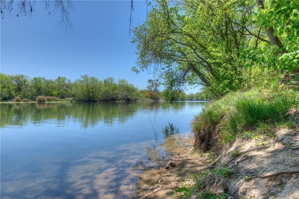 7108 Hester Road Austin, TX 78725 - Photo 22 of 25 a view of a lake in between two large trees