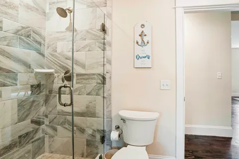a bathroom with a toilet and shower