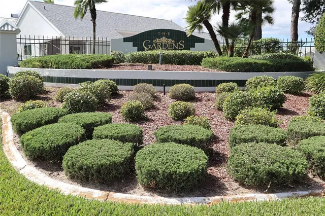 front view of a house with a yard and potted plants