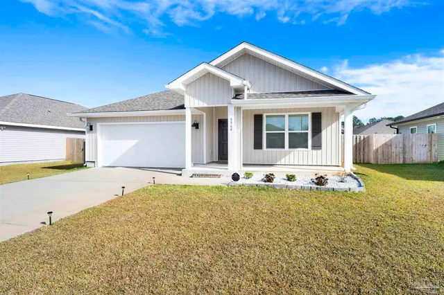 a view of a house with swimming pool and a yard