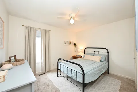 a bedroom with a bed and a chandelier