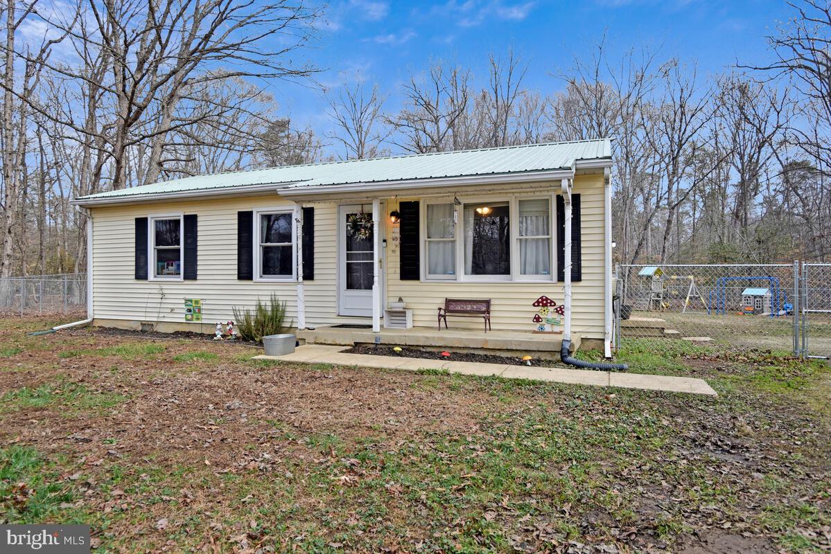 5850 Fire Tower Road Welcome, MD 20693 - Photo 1 of 23 a front view of a house with a yard and trees