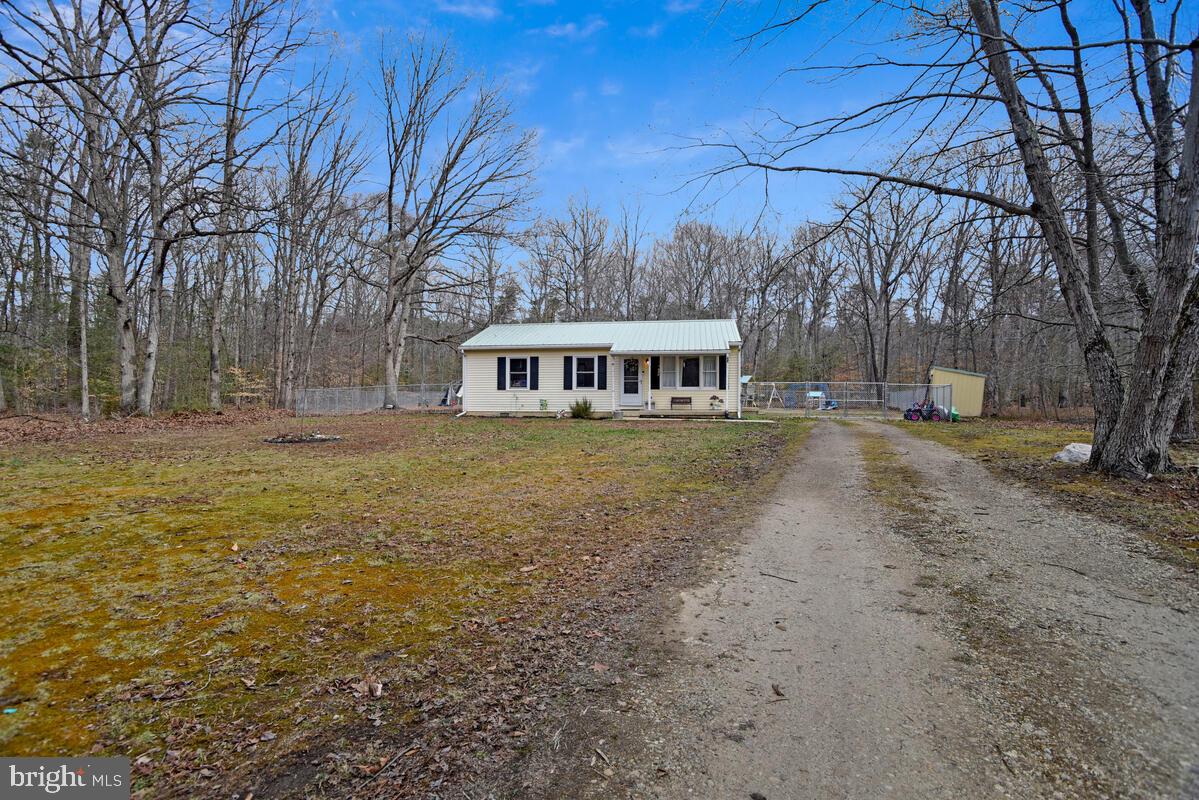 5850 Fire Tower Road Welcome, MD 20693 - Photo 22 of 23 a view of a house with a yard covered with snow and trees