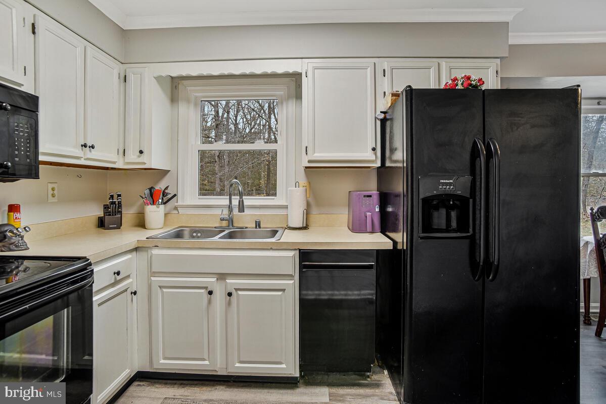 5850 Fire Tower Road Welcome, MD 20693 - Photo 7 of 23 a kitchen with stainless steel appliances a refrigerator sink and cabinets