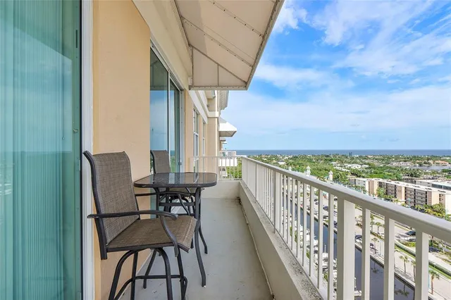 a view of balcony with chairs and wooden fence
