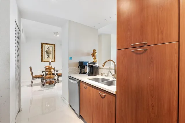 a kitchen with a sink and a refrigerator