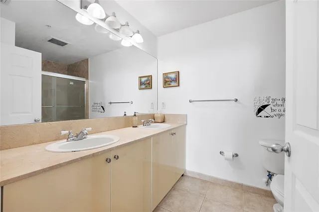 a bathroom with a sink a mirror and a shower