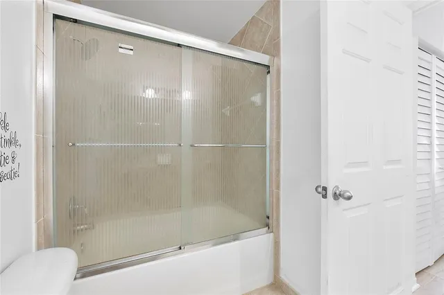 a bathroom with a shower and a bath tub