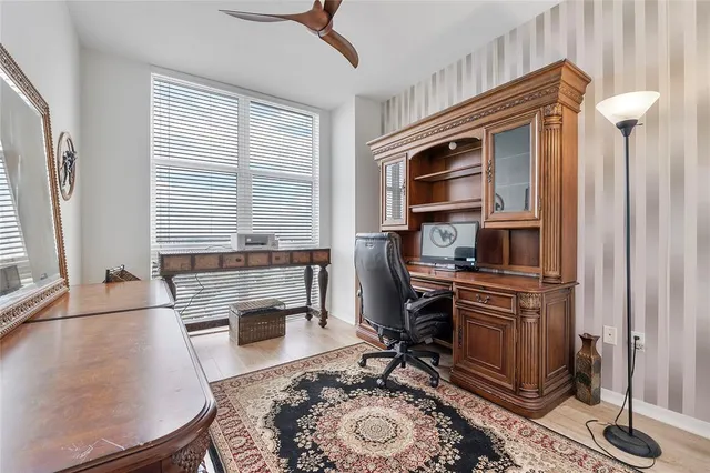 a living room with furniture a rug and a window