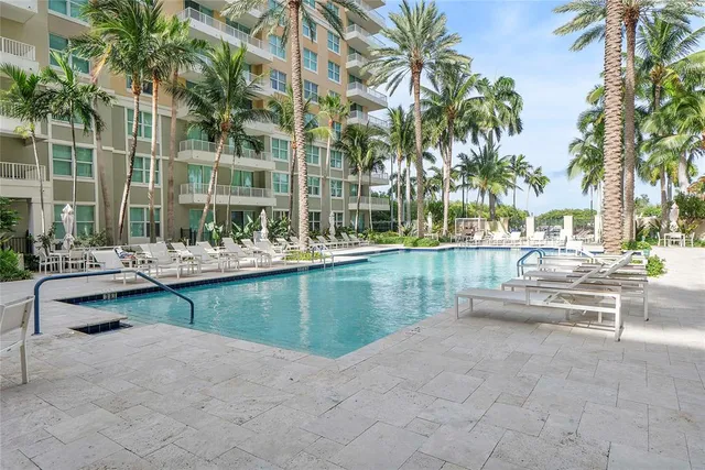 a view of swimming pool with outdoor seating and plants