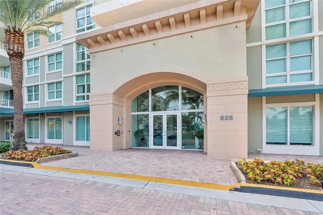 a view of front door of house with large windows