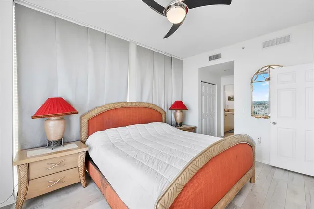 a bedroom with a bed and a lamp