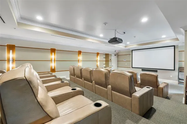 a media room with lots of chairs and a projector screen