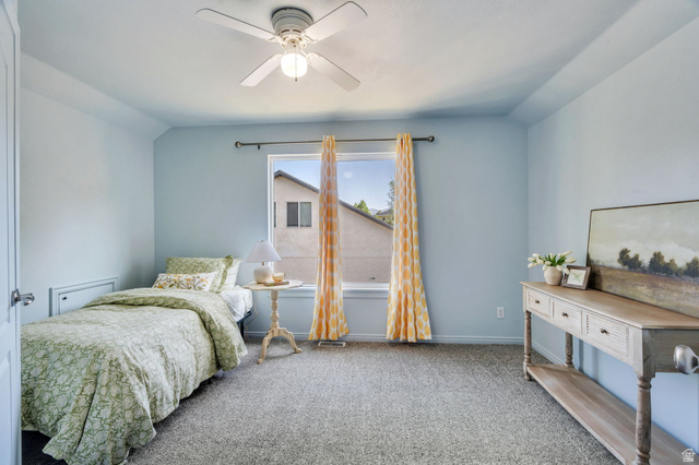 1727 South Sandhill Road Orem, UT 84058 - Photo 17 of 27 Carpeted room featuring a ceiling fan with integrated lighting, a window with a curtain rod, and light blue wall tones