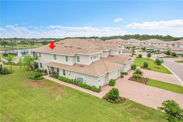 an aerial view of residential houses with outdoor space and trees