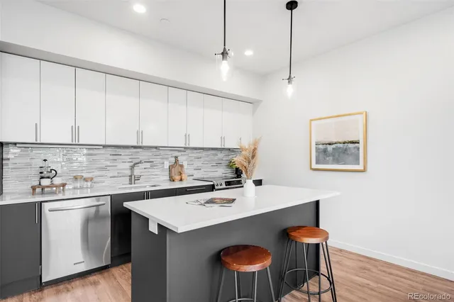 a kitchen with a sink cabinets and wooden floor