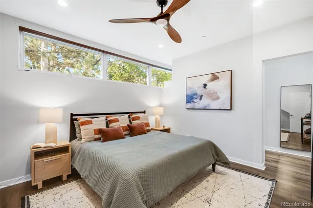 a bedroom with a bed and wooden floor