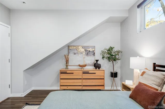 a bedroom with furniture and a potted plant