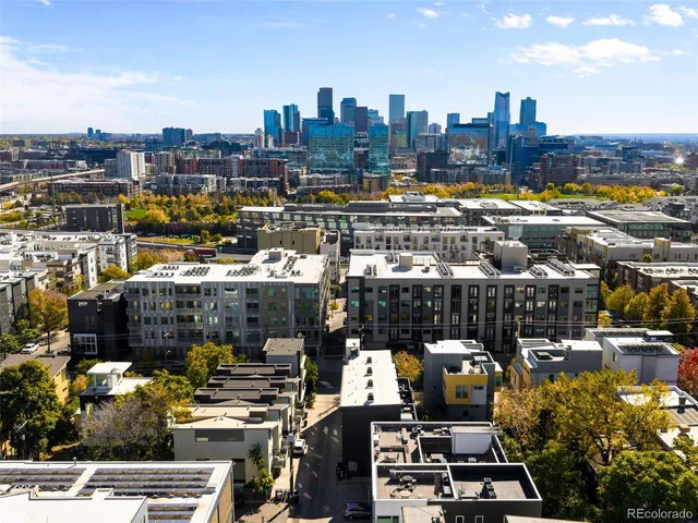 a balcony with wooden floor table and chairs
