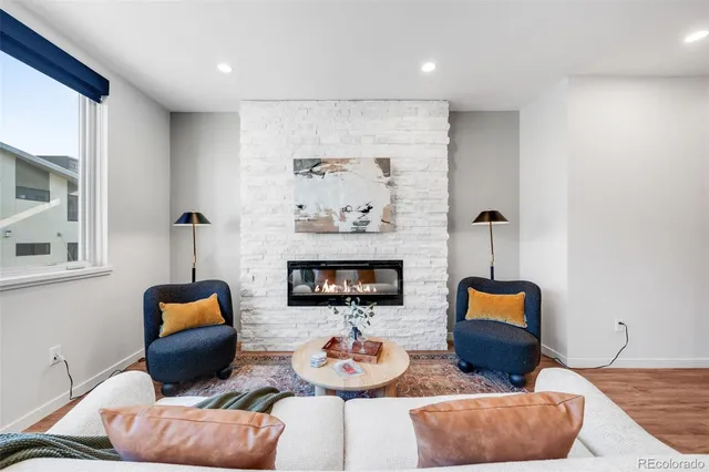 a living room with furniture and a lamp