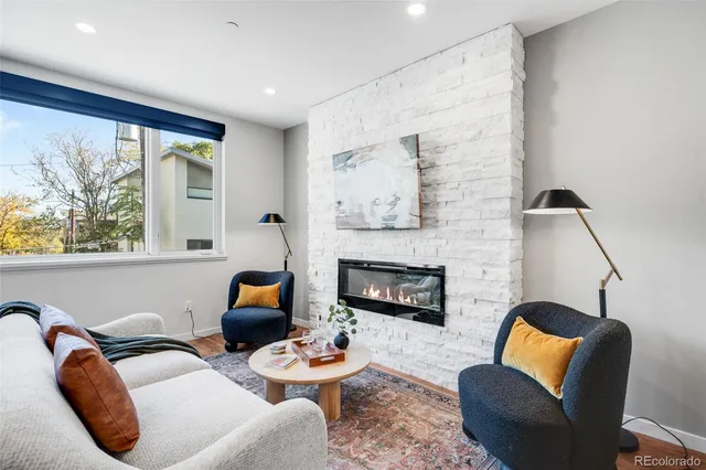 a living room with furniture and a fireplace